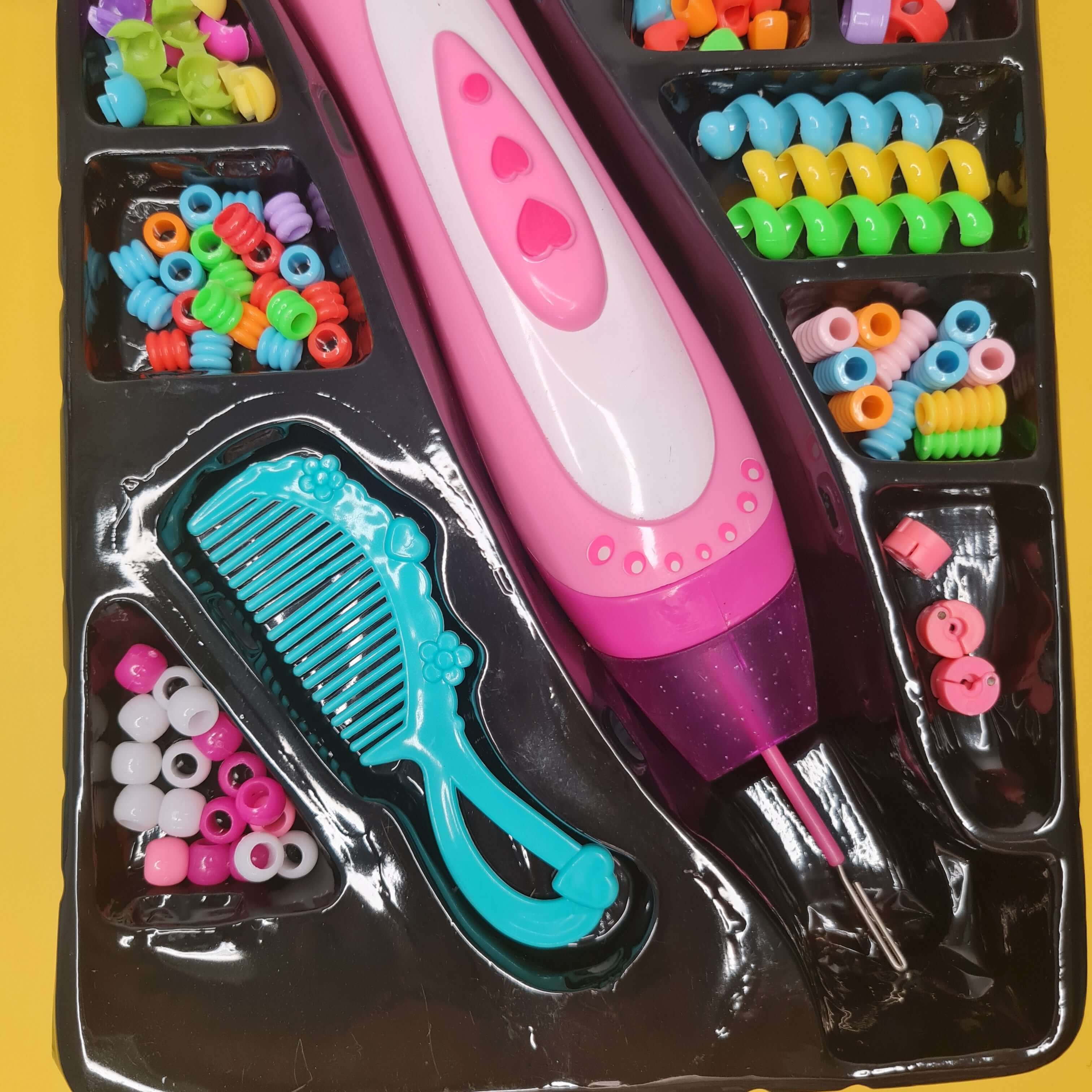 Children's hair styling set with pink brush, blue comb, and colorful beads on a yellow background.